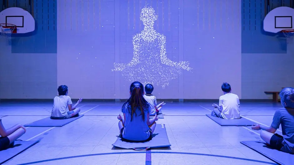 Kids doing yoga in a gymnasium