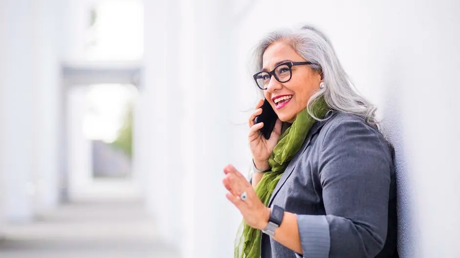 A woman with glasses talking on a mobile phone