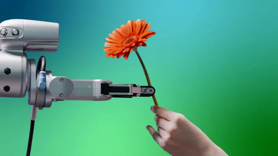 A robotic arm hands over a flower to a human hand