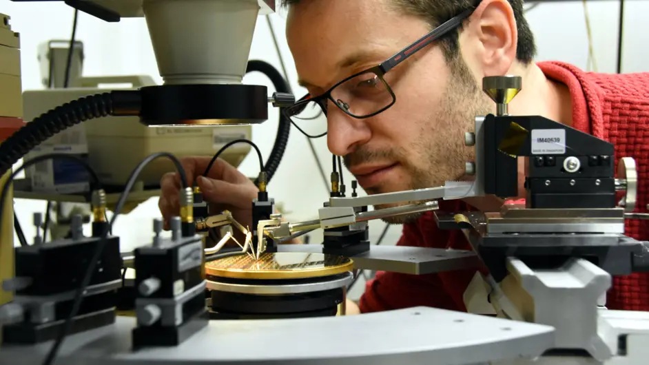 Joan Ramirez working with a III-V integrated laser on a silicon wafer