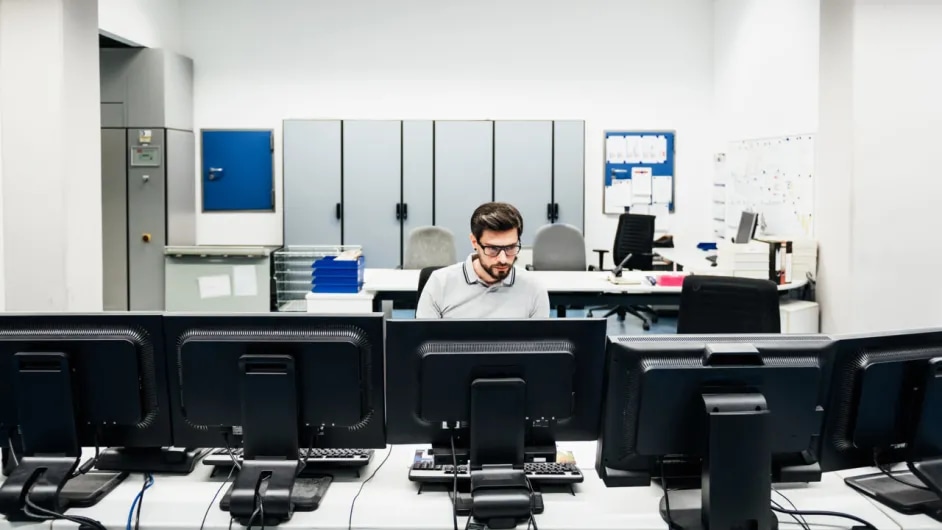 A man working on a computer in an office